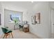 Bright office space with modern desk, dual monitors, chair, and natural light from a window overlooking the neighborhood at 16637 Shoshone St, Broomfield, CO 80023