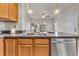 Well-designed kitchen with a double sink, sleek dishwasher, and views of the adjacent living room, creating an open space at 3372 Central Park Blvd, Denver, CO 80238