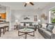 Bright living room with comfortable gray sofas, decorative wall art, and natural light streaming through the window at 3372 Central Park Blvd, Denver, CO 80238