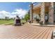 Backyard featuring an outdoor fireplace, deck, and stone accents at 2370 W 152Nd Ave, Broomfield, CO 80023