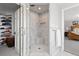 Elegant bathroom showcases a marble shower with a glass door, complemented by an adjacent closet and views of the bedroom at 2370 W 152Nd Ave, Broomfield, CO 80023