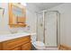 Bathroom featuring a glass-enclosed shower, a traditional vanity with a mirror, and a toilet, all in a well-lit space at 2370 W 152Nd Ave, Broomfield, CO 80023