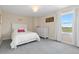 Light-filled bedroom featuring a white bed, plush carpet, and a window with a scenic outdoor view at 2370 W 152Nd Ave, Broomfield, CO 80023