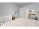 Comfortable bedroom featuring plush carpet, a white dresser, a desk, and a view to an adjoining room at 2370 W 152Nd Ave, Broomfield, CO 80023