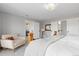 Serene bedroom with plush carpet, neutral walls, a cozy chair, and open doorways to adjoining rooms at 2370 W 152Nd Ave, Broomfield, CO 80023