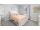 Charming bedroom with a white bed, plush carpet, window with lilac curtains, and decorative artwork at 2370 W 152Nd Ave, Broomfield, CO 80023