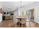 Well-lit dining area featuring hardwood flooring, a chandelier, and access to the living room at 2370 W 152Nd Ave, Broomfield, CO 80023