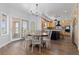 Open dining room area with hardwood floors, elegant chandelier, and views to the backyard at 2370 W 152Nd Ave, Broomfield, CO 80023