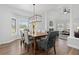 Elegant dining room with wood floors, statement chandelier, and large windows, creating a perfect dining space at 2370 W 152Nd Ave, Broomfield, CO 80023