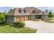 Beautiful home featuring a three-car garage, stone accents, mature bushes, and a well-manicured lawn at 2370 W 152Nd Ave, Broomfield, CO 80023