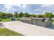 Large multi-car garage with overhead doors and adjacent tennis court, creating ample space for recreation and storage at 2370 W 152Nd Ave, Broomfield, CO 80023