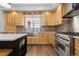Bright kitchen with custom cabinets, stainless steel appliances, island, and hardwood flooring at 2370 W 152Nd Ave, Broomfield, CO 80023