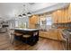 Modern kitchen with custom wood cabinets, stainless steel appliances, and a center island with seating at 2370 W 152Nd Ave, Broomfield, CO 80023