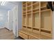 Mud room with built-in storage lockers and bench, leading to laundry room at 2370 W 152Nd Ave, Broomfield, CO 80023