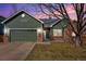 Inviting single Gathering home featuring a two-car garage, brick accents and solar panels on the roof at 13141 Birch Way, Thornton, CO 80241