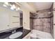 Updated bathroom with a shower-tub combination, black countertops, and tile backsplash at 3124 S Wheeling Way # 102, Aurora, CO 80014