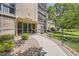 Inviting entrance to Building 209 with accessible ramp and well-maintained landscaping and stone entryway at 3124 S Wheeling Way # 102, Aurora, CO 80014