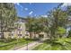 Exterior view of the building featuring mature trees, well-kept lawns, and a welcoming entrance at 3124 S Wheeling Way # 102, Aurora, CO 80014