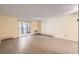 Open and airy living area with sliding glass doors to the outside and minimalist design at 3124 S Wheeling Way # 102, Aurora, CO 80014