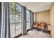 Cozy sunroom with large windows and two patterned chairs at 3124 S Wheeling Way # 102, Aurora, CO 80014
