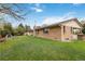 Spacious backyard with a brick home and outdoor kitchen at 6288 S Harlan Way, Littleton, CO 80123