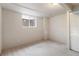 Basement bedroom showcases a neutral carpet and natural light from the egress window at 6288 S Harlan Way, Littleton, CO 80123