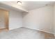 Carpeted basement room featuring a single light fixture and an adjacent doorway at 6288 S Harlan Way, Littleton, CO 80123