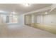 Open basement with combined carpeted and tiled areas, bright lighting, and neutral tones at 6288 S Harlan Way, Littleton, CO 80123