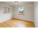 Bedroom with hardwood floors, white walls, white trim, and dual windows at 6288 S Harlan Way, Littleton, CO 80123