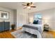 Bedroom featuring ceiling fan, area rug, hardwood floors, and closet with bifold doors at 6288 S Harlan Way, Littleton, CO 80123