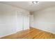 Cozy bedroom features hardwood floors, closet with bifold doors, and white wall trim at 6288 S Harlan Way, Littleton, CO 80123