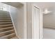 Hallway featuring stairs leading upstairs and closet with white sliding doors at 6288 S Harlan Way, Littleton, CO 80123