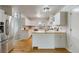 Bright kitchen with white cabinetry, butcher block countertops, and stainless steel appliances at 6288 S Harlan Way, Littleton, CO 80123