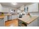 Well-lit kitchen with wood countertops, stainless steel appliances, and white cabinetry at 6288 S Harlan Way, Littleton, CO 80123