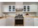 Updated kitchen with butcher block countertops and stainless steel gas range at 6288 S Harlan Way, Littleton, CO 80123