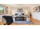 Well-lit living room with hardwood floors, a comfortable sofa, and elegant decor at 6288 S Harlan Way, Littleton, CO 80123