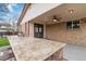 Covered outdoor kitchen with granite counters and a built-in BBQ at 6288 S Harlan Way, Littleton, CO 80123