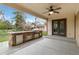 Covered outdoor kitchen with a built-in grill and bar at 6288 S Harlan Way, Littleton, CO 80123