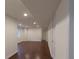 Finished basement featuring wood-look floors, neutral walls, recessed lighting, and a convenient doorway at 10581 Pearlwood Cir, Highlands Ranch, CO 80126