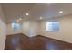 Basement space featuring wood-look flooring, neutral walls, recessed lighting, and window views at 10581 Pearlwood Cir, Highlands Ranch, CO 80126