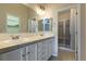 Bathroom featuring double sinks and a walk-in shower at 10581 Pearlwood Cir, Highlands Ranch, CO 80126