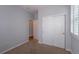 Bright bedroom with carpeted floors, closet, and two entry doors at 10581 Pearlwood Cir, Highlands Ranch, CO 80126