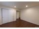 Bedroom with wood-look flooring, neutral walls, and closet space offers a cozy and functional design at 10581 Pearlwood Cir, Highlands Ranch, CO 80126
