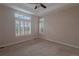 Spacious carpeted bedroom with trey ceiling, ceiling fan, and shuttered windows at 10581 Pearlwood Cir, Highlands Ranch, CO 80126