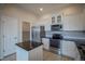 Modern kitchen featuring stainless steel appliances, granite countertops, white cabinets, and center island at 10581 Pearlwood Cir, Highlands Ranch, CO 80126
