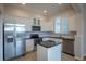 Modern kitchen featuring stainless steel appliances, white cabinets, and granite countertops at 10581 Pearlwood Cir, Highlands Ranch, CO 80126
