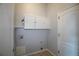 Functional laundry room with storage cabinets and convenient utility hookups at 10581 Pearlwood Cir, Highlands Ranch, CO 80126