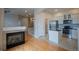 Open-concept view of the living room, kitchen, stairs, and fireplace at 10581 Pearlwood Cir, Highlands Ranch, CO 80126