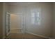 Office with tiled floor, bright windows, and French doors to an adjoining room at 10581 Pearlwood Cir, Highlands Ranch, CO 80126
