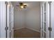 Bright office with a ceiling fan, carpeted floor, and double French doors at 10581 Pearlwood Cir, Highlands Ranch, CO 80126